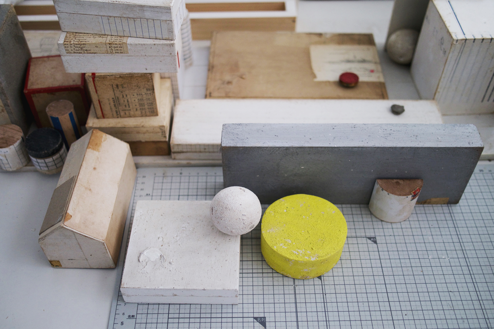 Works in progress with yellow cylinder, house and sphere