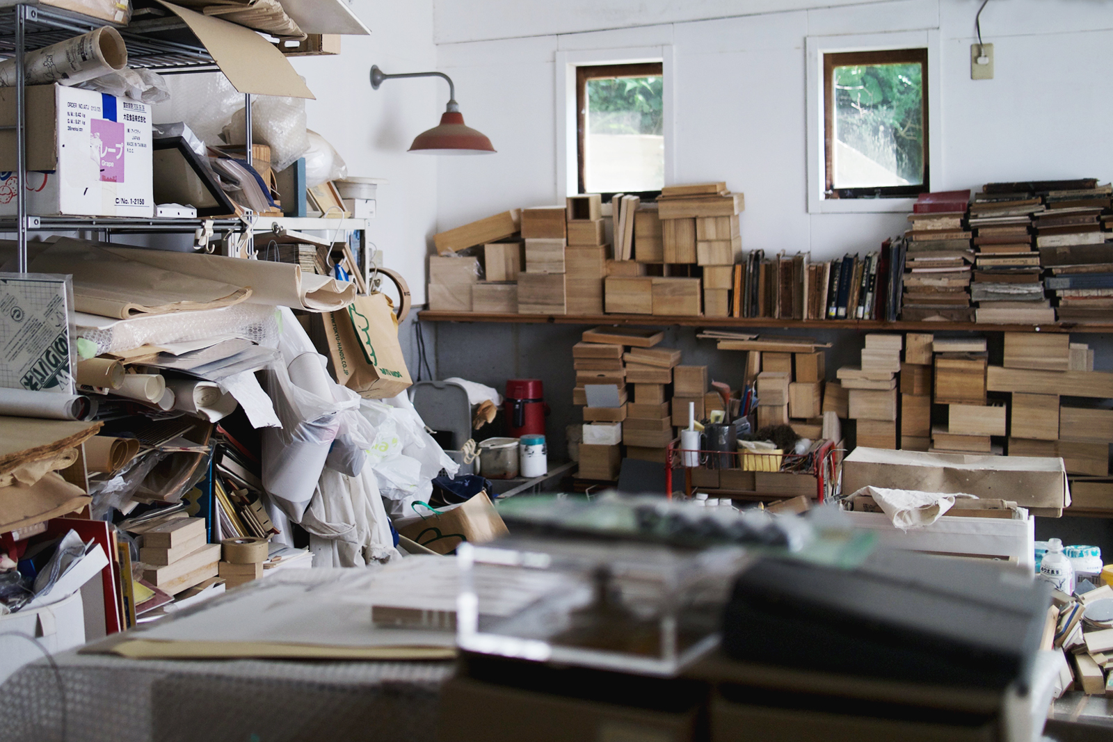 Inside the studio of Michiko Iwata lined with materials and stacks of wood blocks