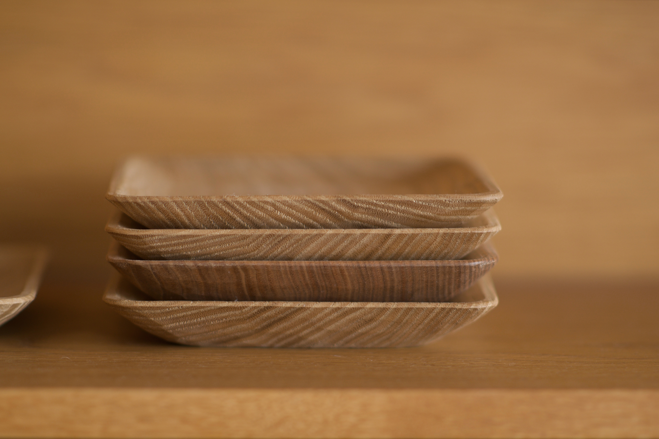 Stacked mountain cherry wooden bread plates by Ryuji Mitani