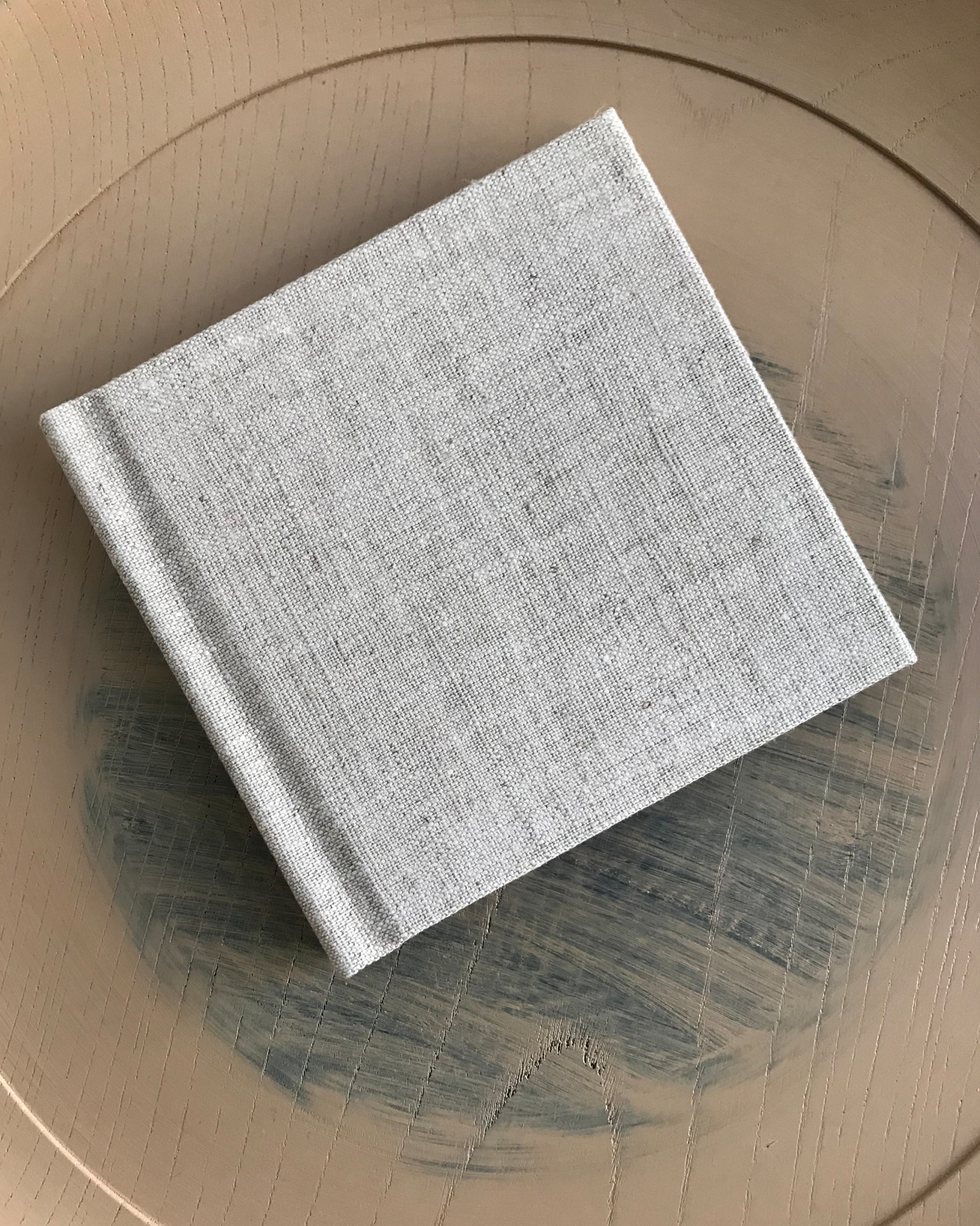 Small square linen covered guestbook for Ryuji Mitani