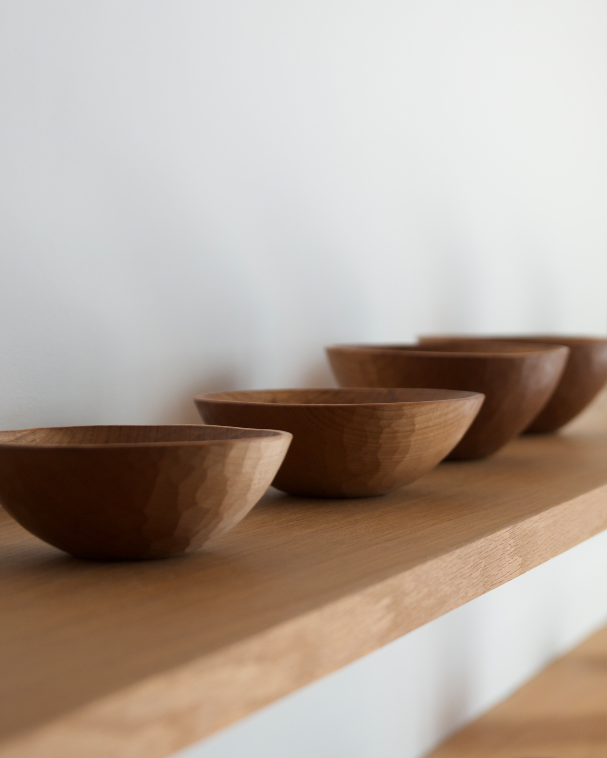 Carved cherry wooden bowls by Ryuji Mitani in a row