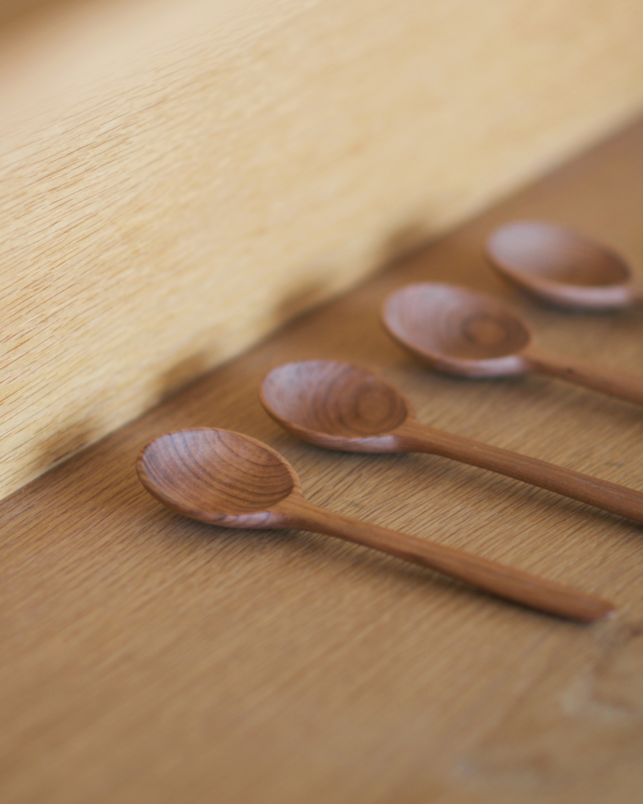 Wooden soup spoons displayed in a neat row at Nalata Nalata