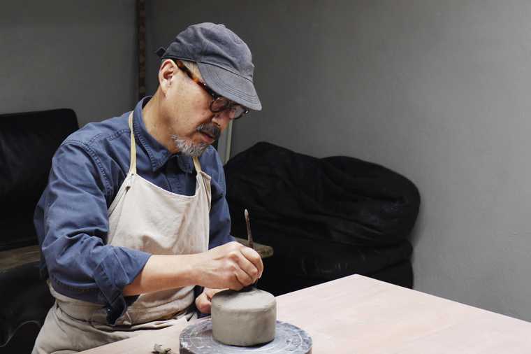 Masanobu Ando in his studio making a gold chawan