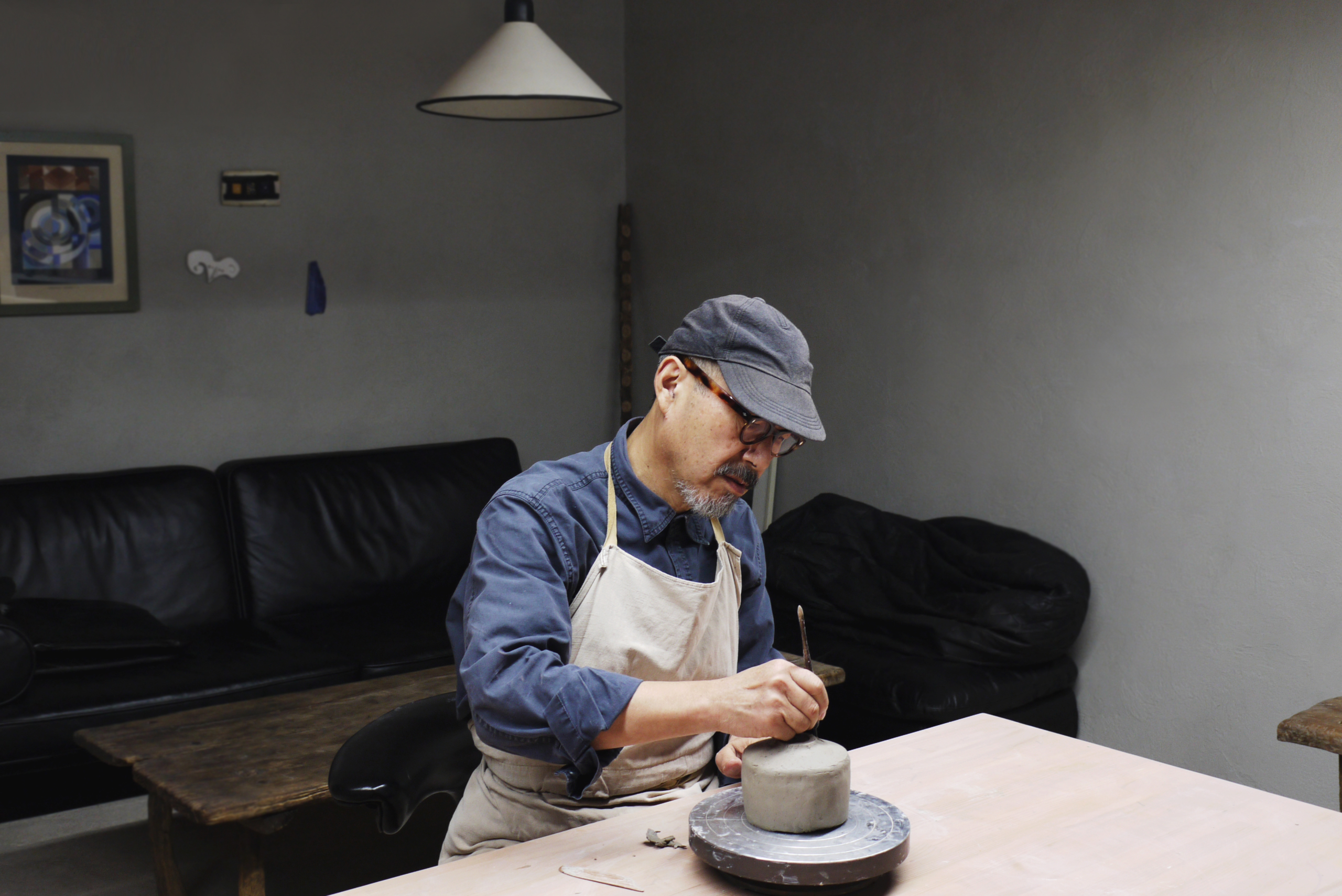 Masanobu Ando in his studio making a gold chawan