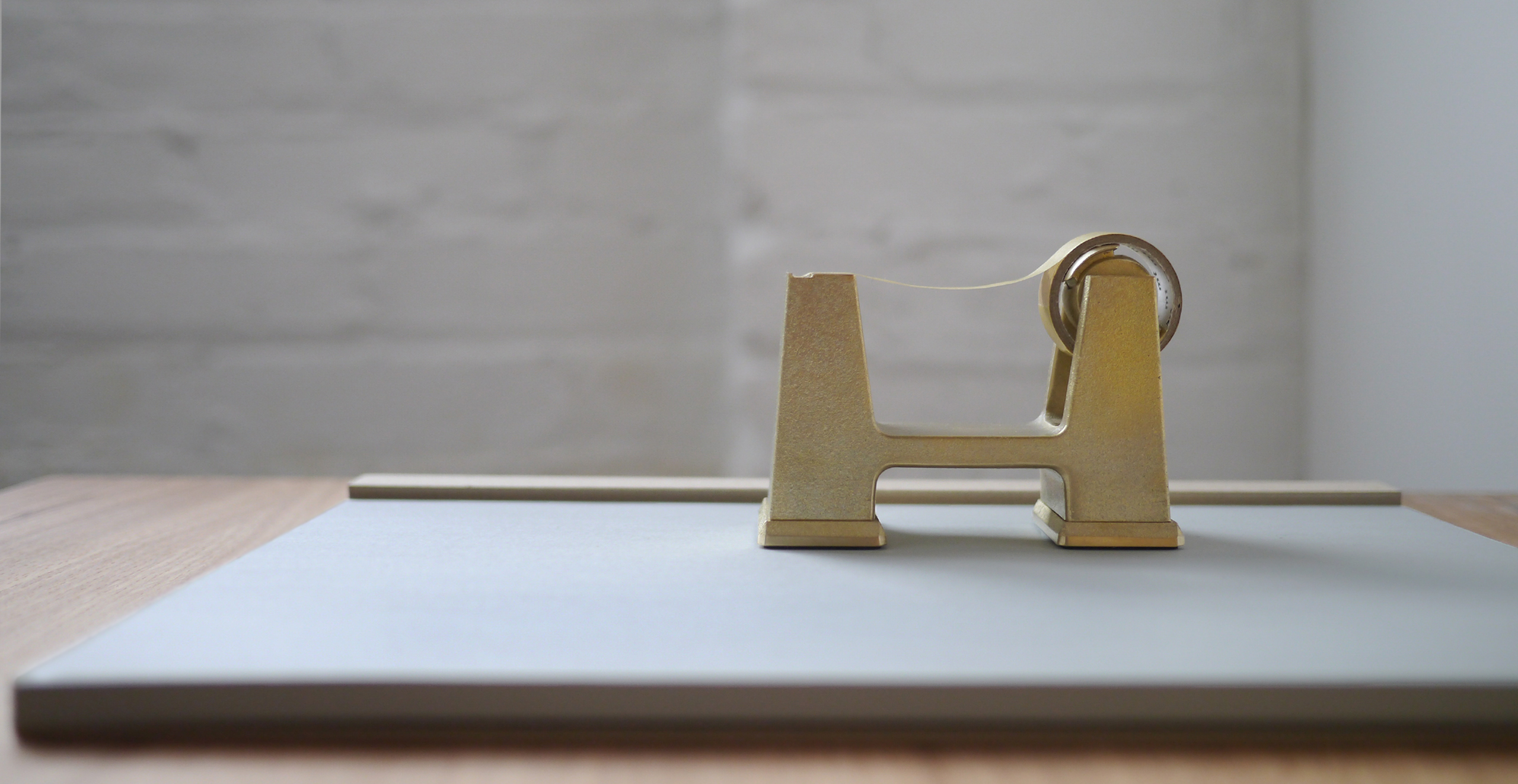 Brass tape dispenser on a desk