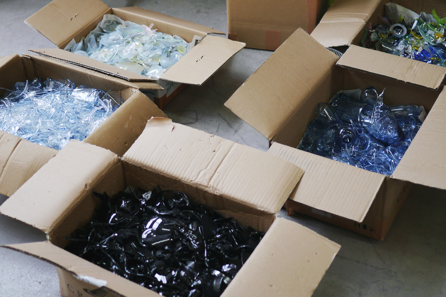 Boxes of recycled light blue glass shards
