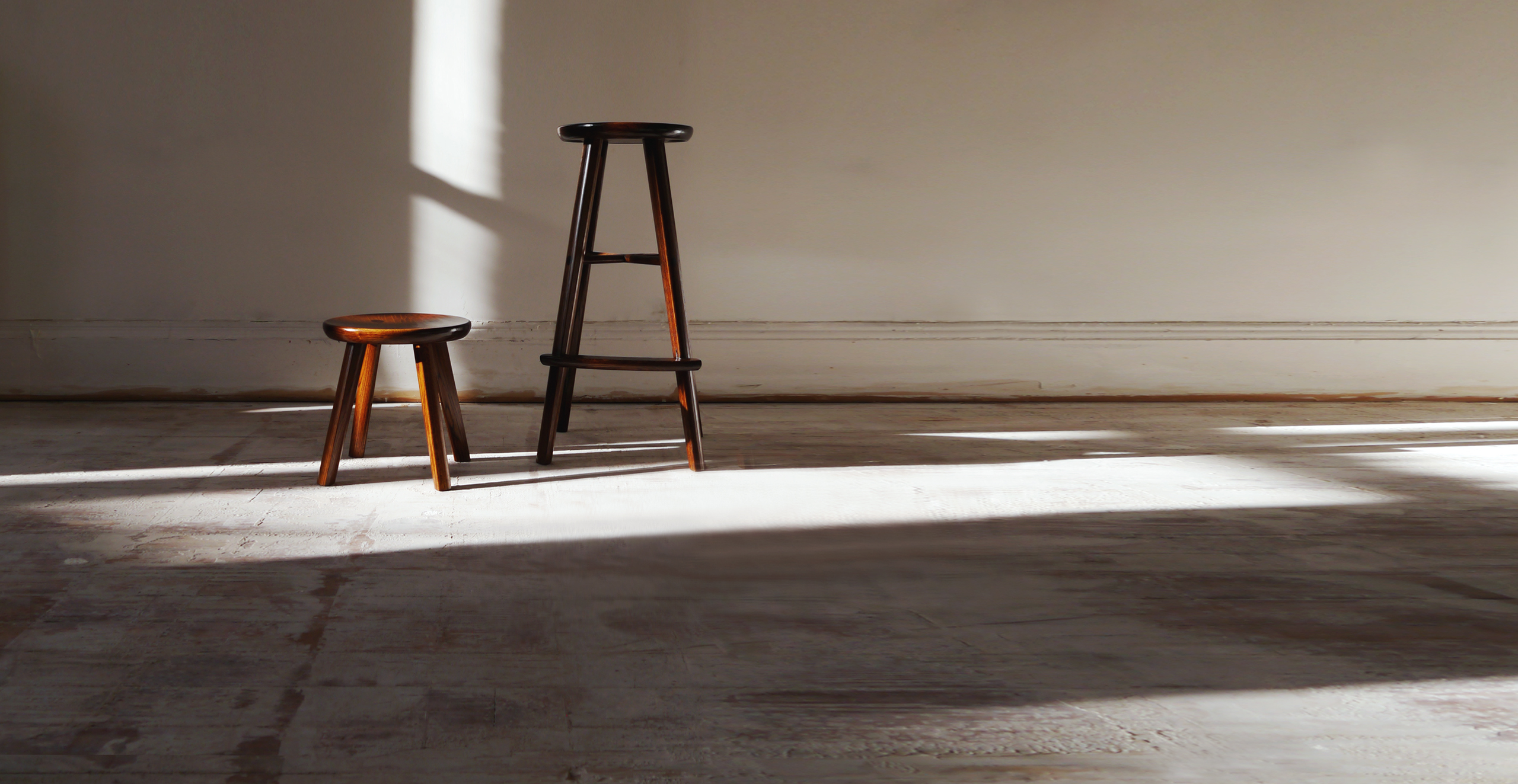 Ibazen lacquered oak wood stool beside a bar stool