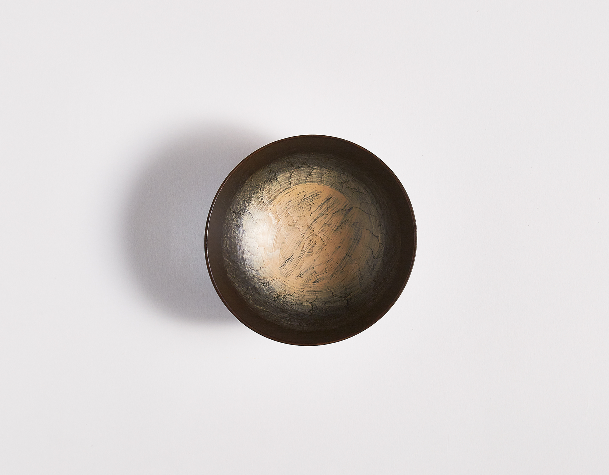 Bird's eye view of black carved wooden bowl with white lacquered interior by Ryuji Mitani