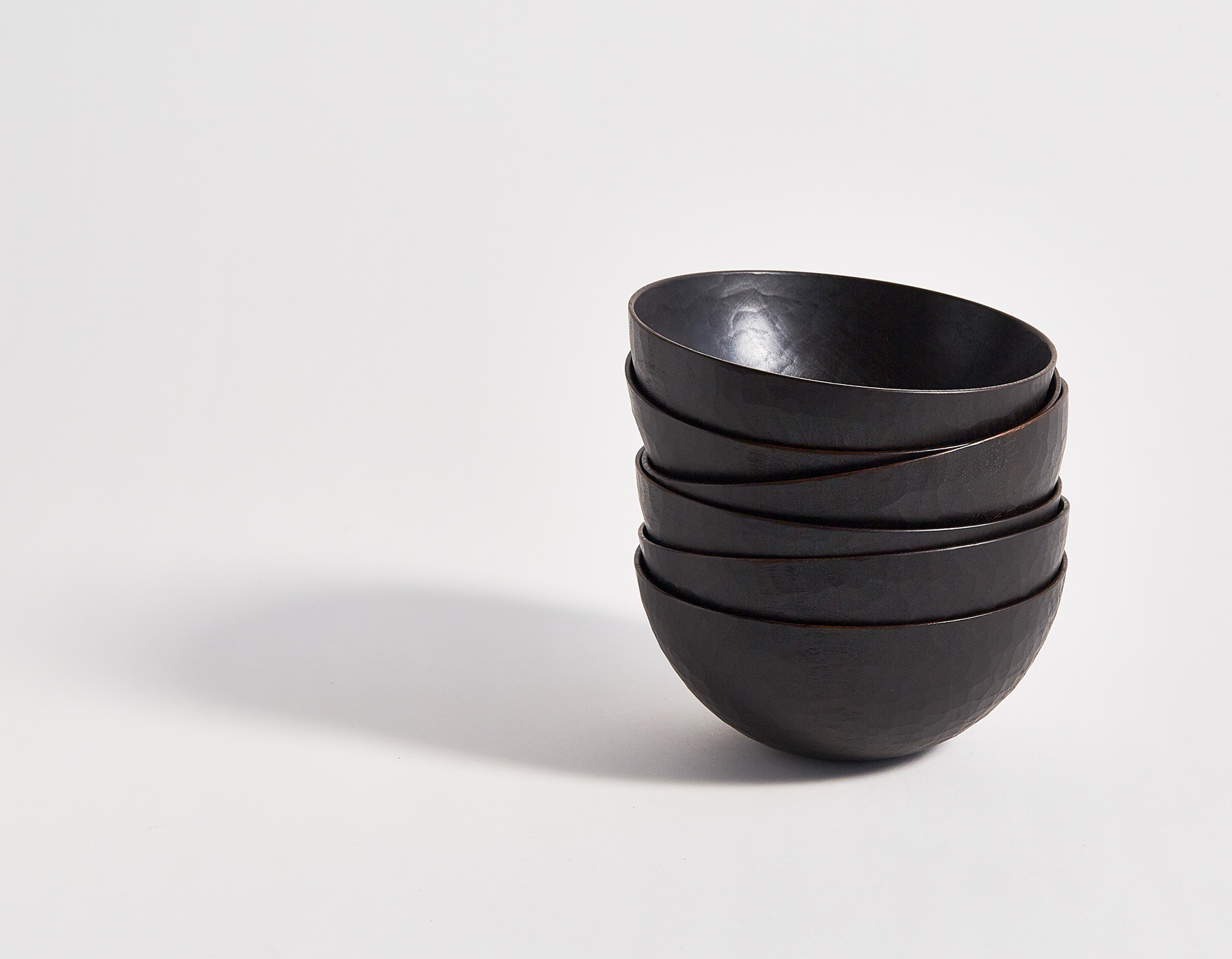 Six black walnut lacquered carved bowls stacked, by Ryuji Mitani