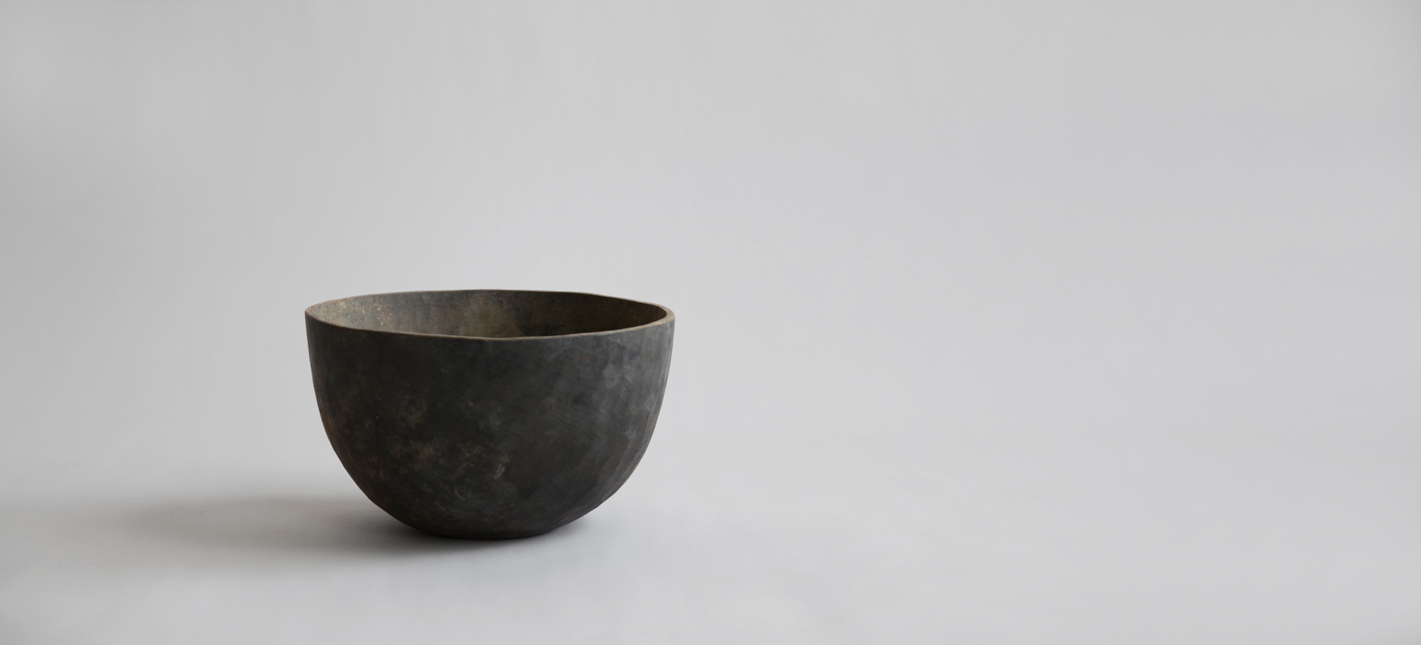 Image of a wood bowl by Ryuji Mitani carved and lacquered to appear very rustic