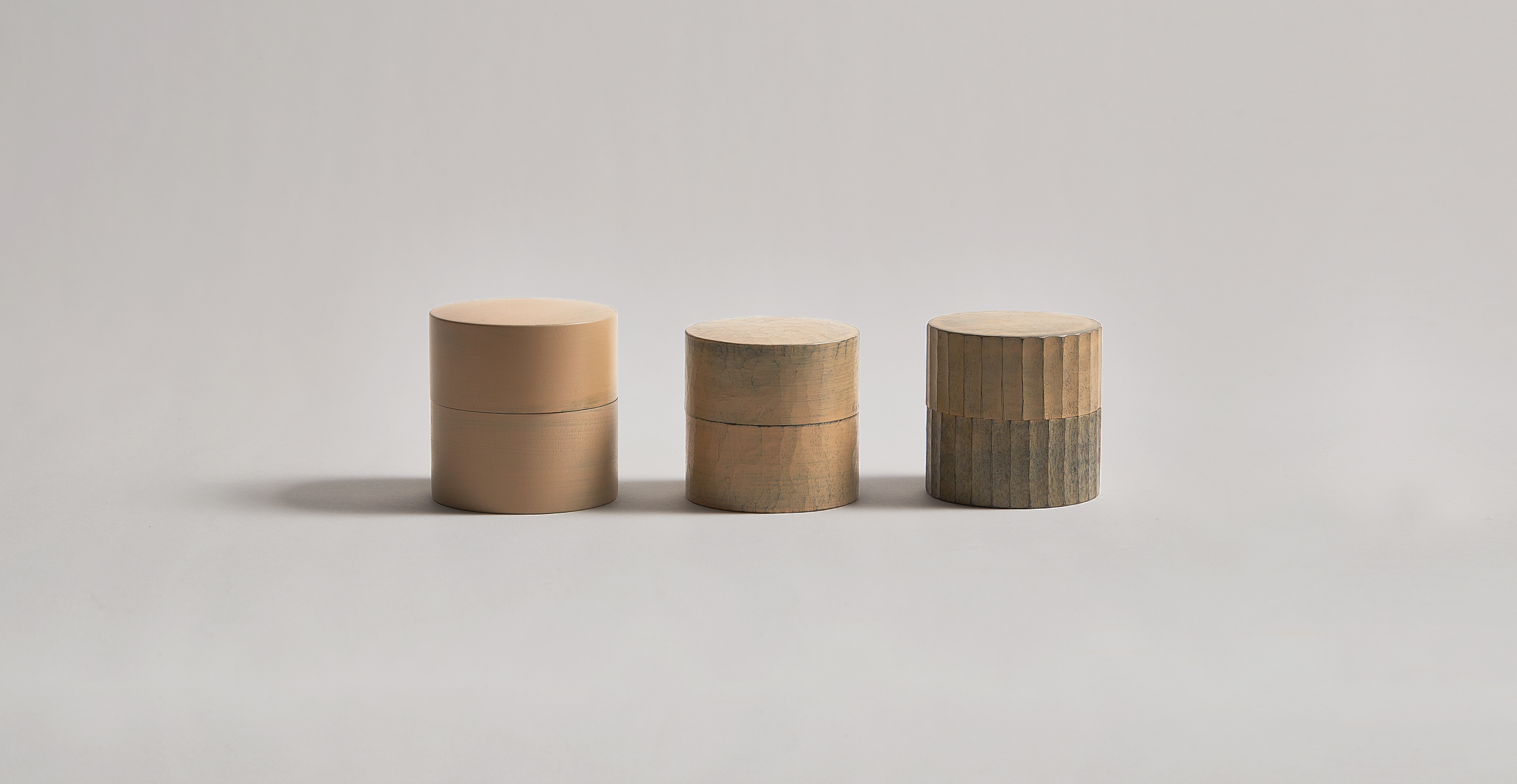 3 white urushi wood handcrafted tea canisters by Ryuji Mitani in a row