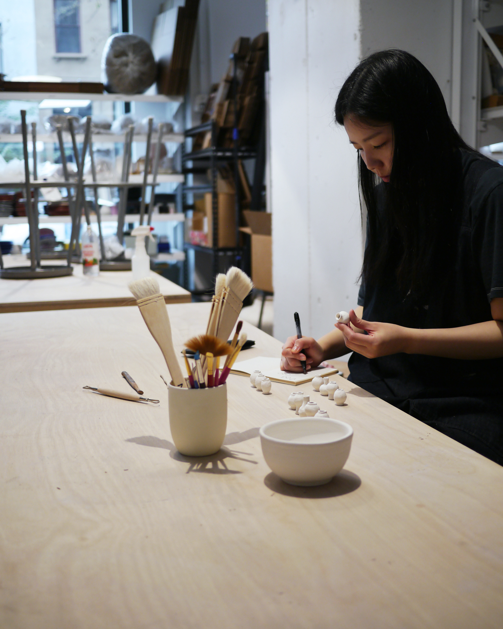 Dani Suji Lee of Dani Sujin Studio at her studio hand building mini group vases