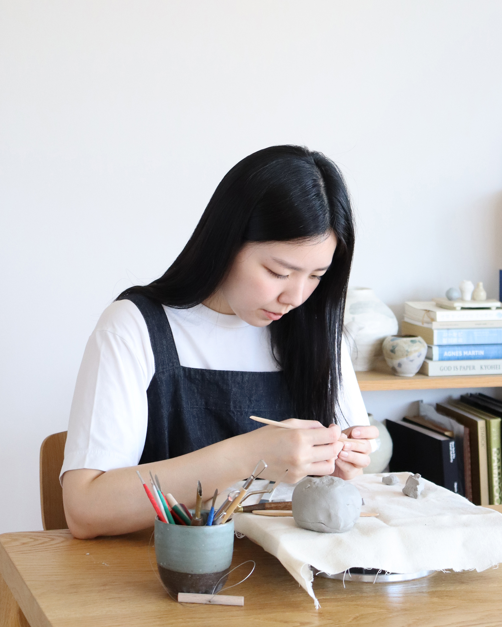 Dani Suji Lee of Dani Sujin Studio at her studio hand building mini group vases