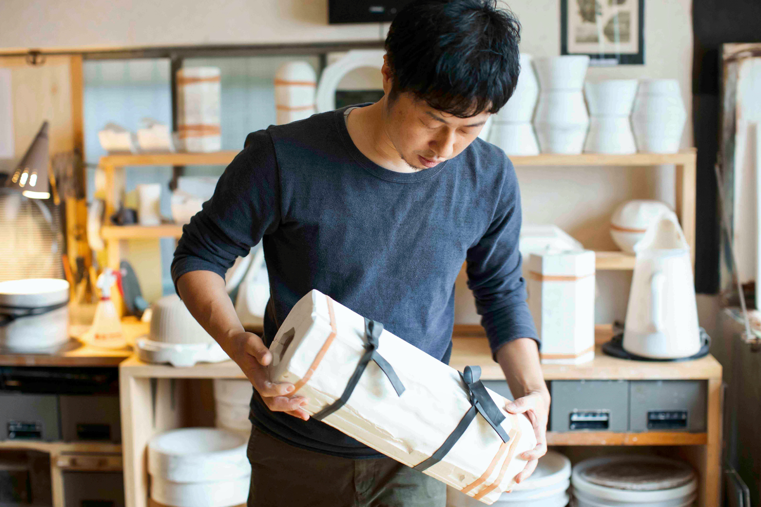 Hirotaka Tobimatsu holding a porcelain split cast mold