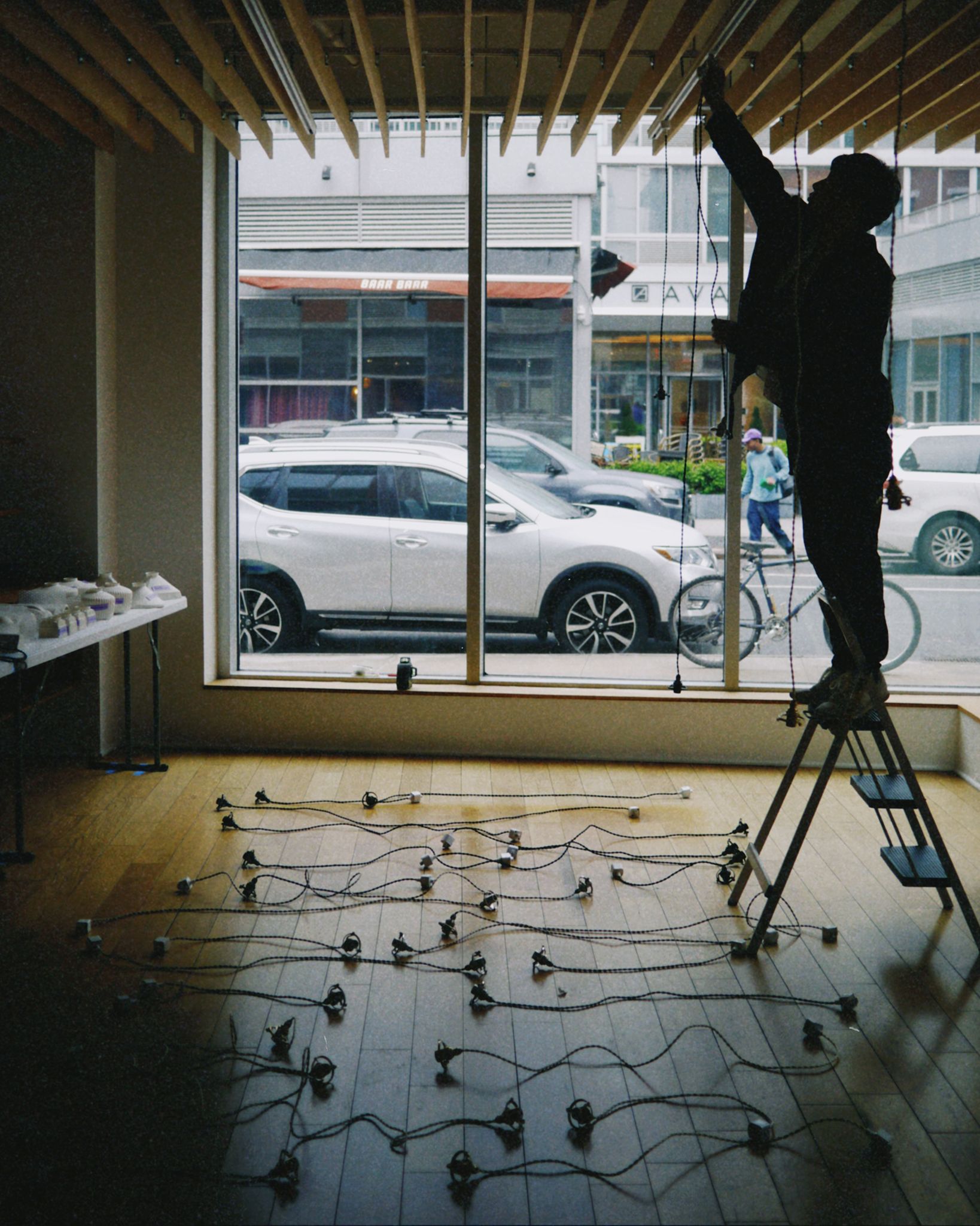 Hirotake Tobimatsu installing porcelain pendant lights