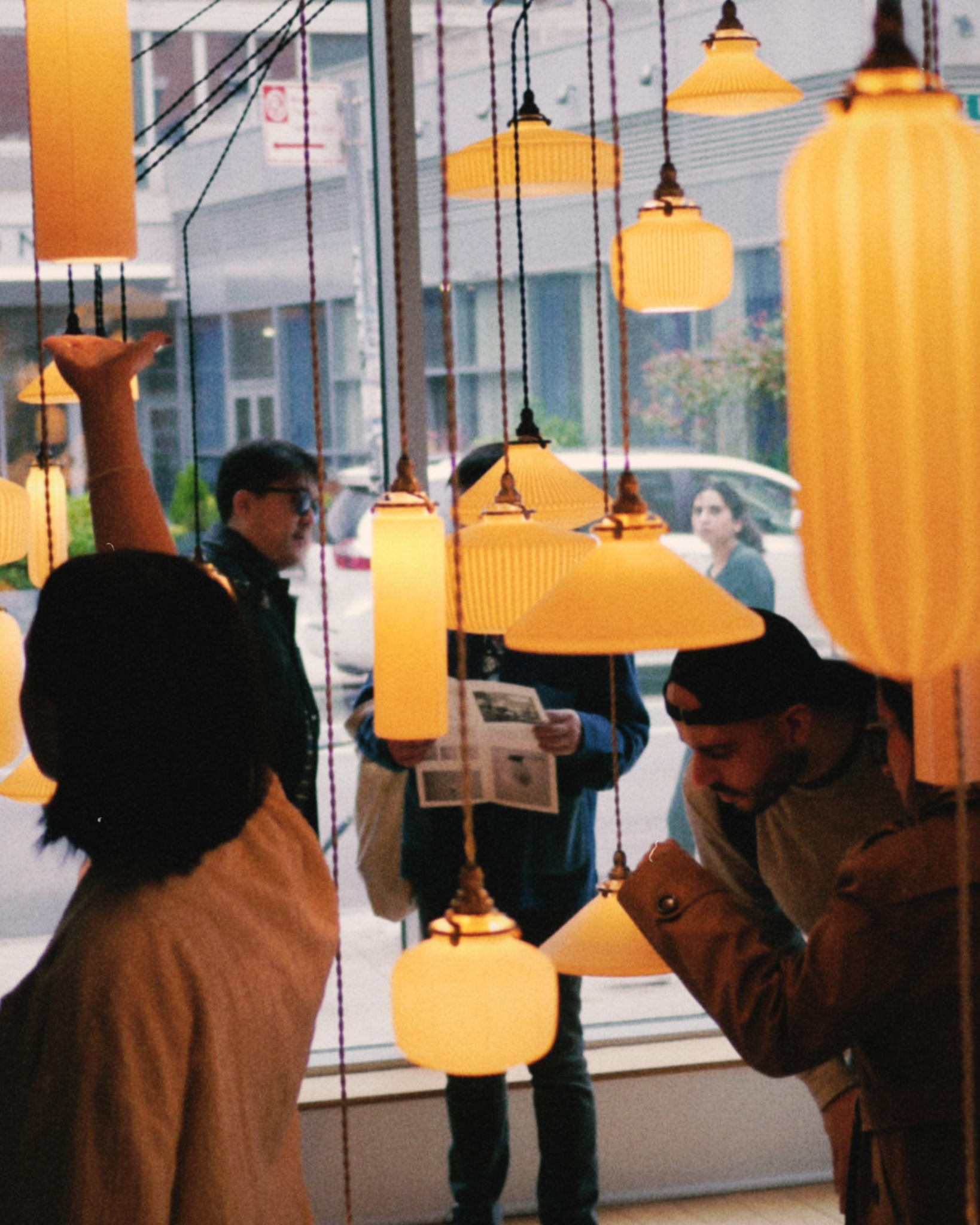 Guests viewing porcelain pendants at Nalata Nalata Casting Light exhibition