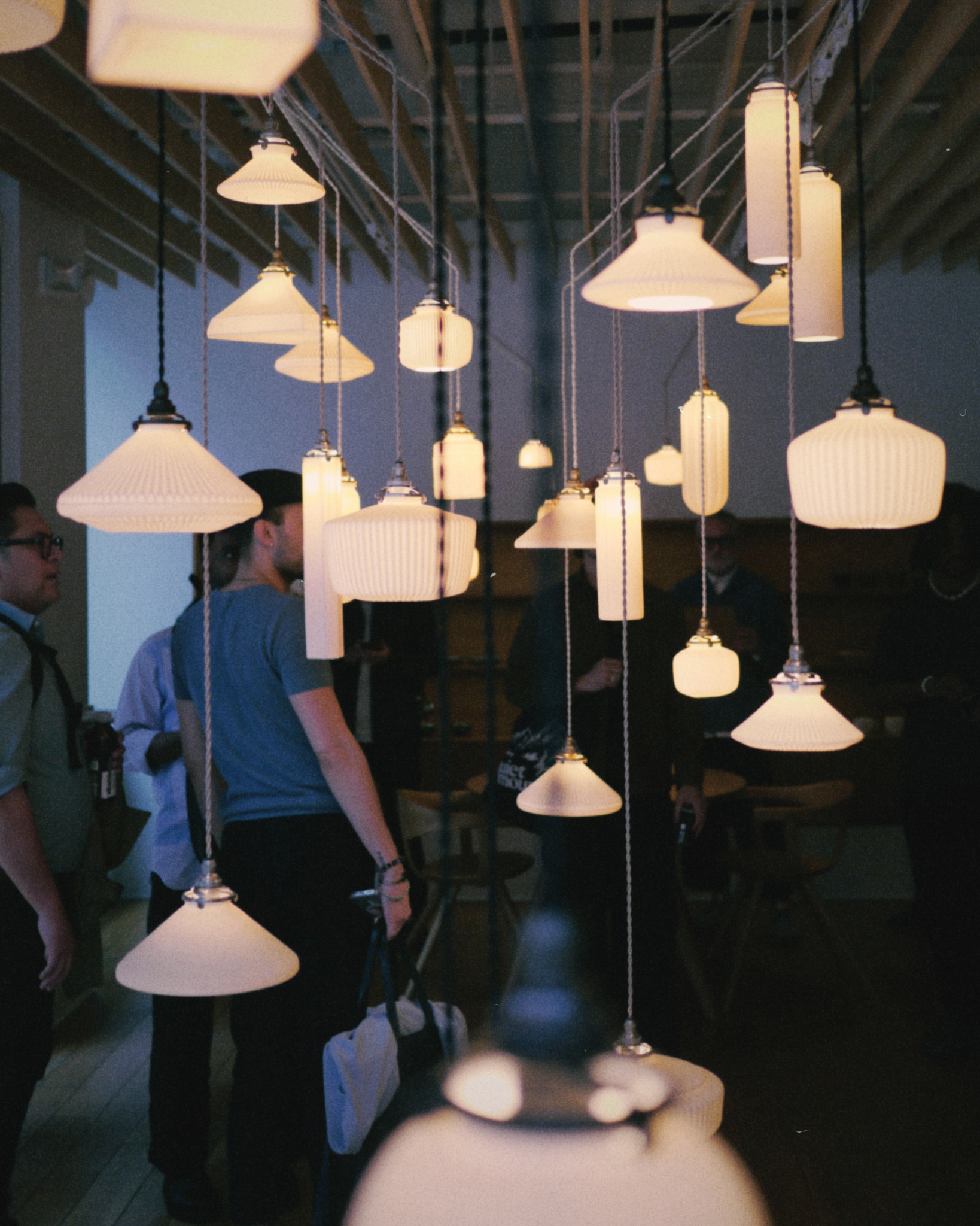 Tobimatsu porcelain pendants and guests at the opening reception of Casting Light