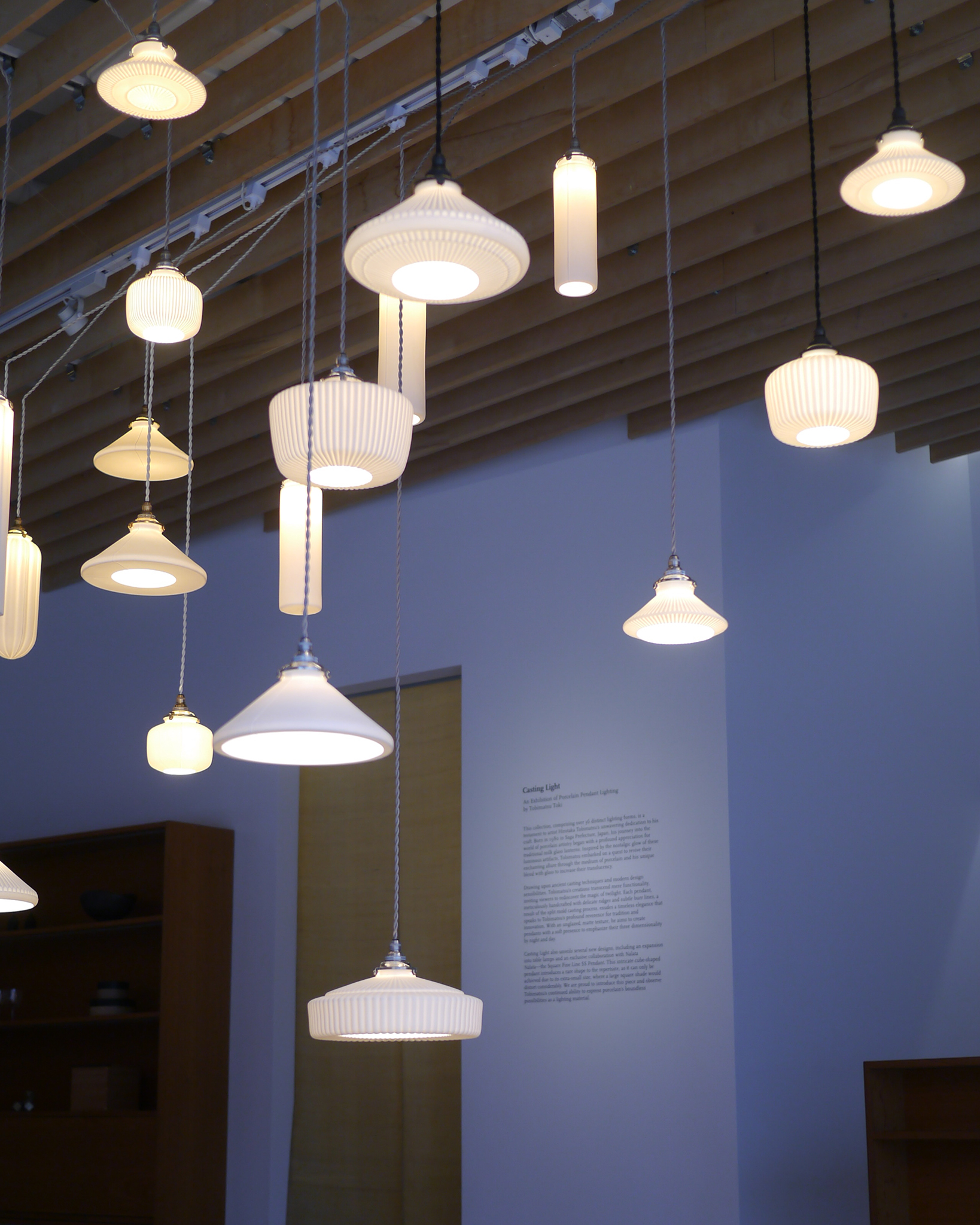 Tobimatsu hanging pendants illuminated in front of the Casting Light Exhibition Statement at Nalata Nalata gallery