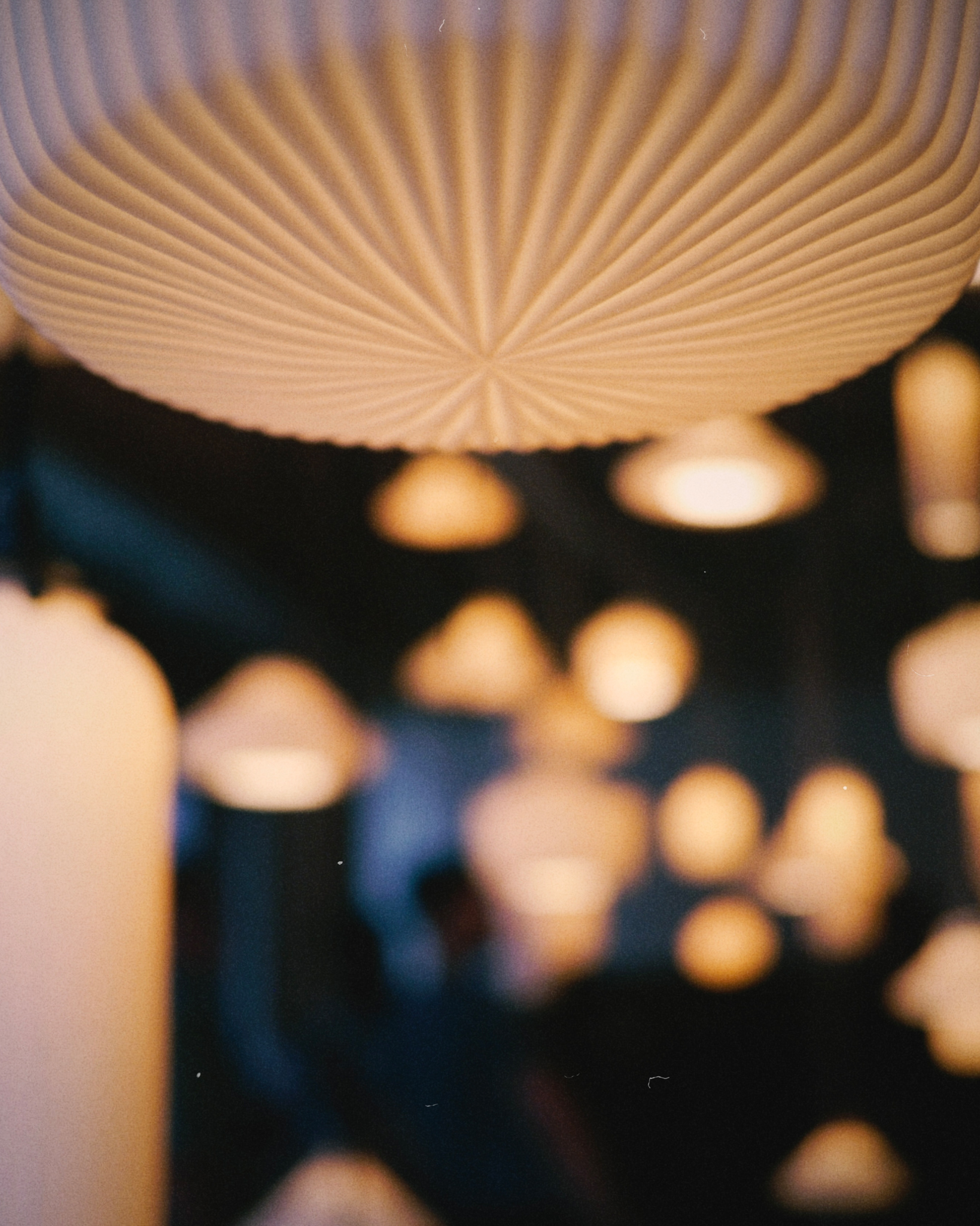 Tobimatsu porcelain ridge drop pendant light in focus in the foreground with other Tobimatsu pendants blurry in background