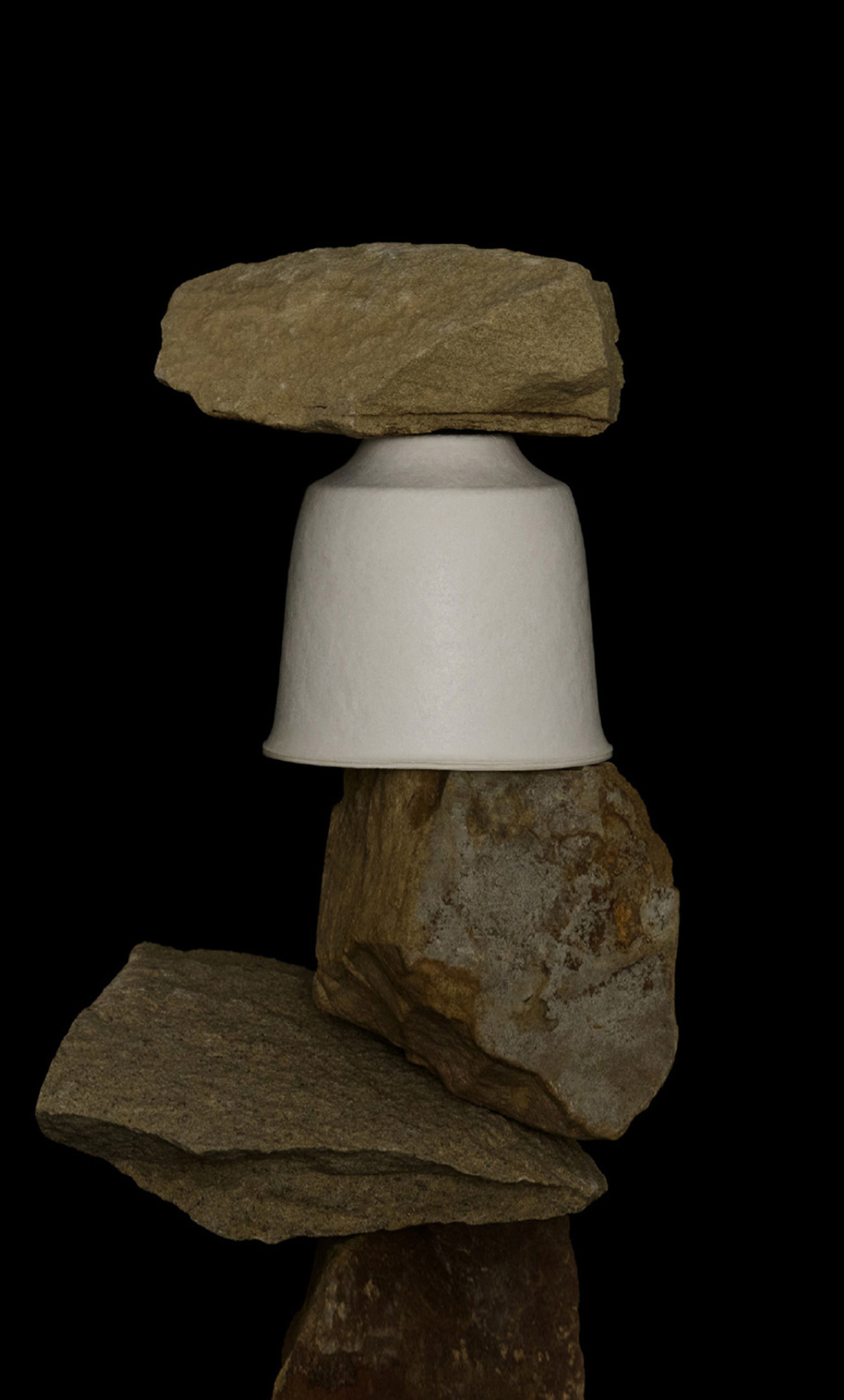 Image of Saboe T Collection tea container stacked amongst rocks with black background