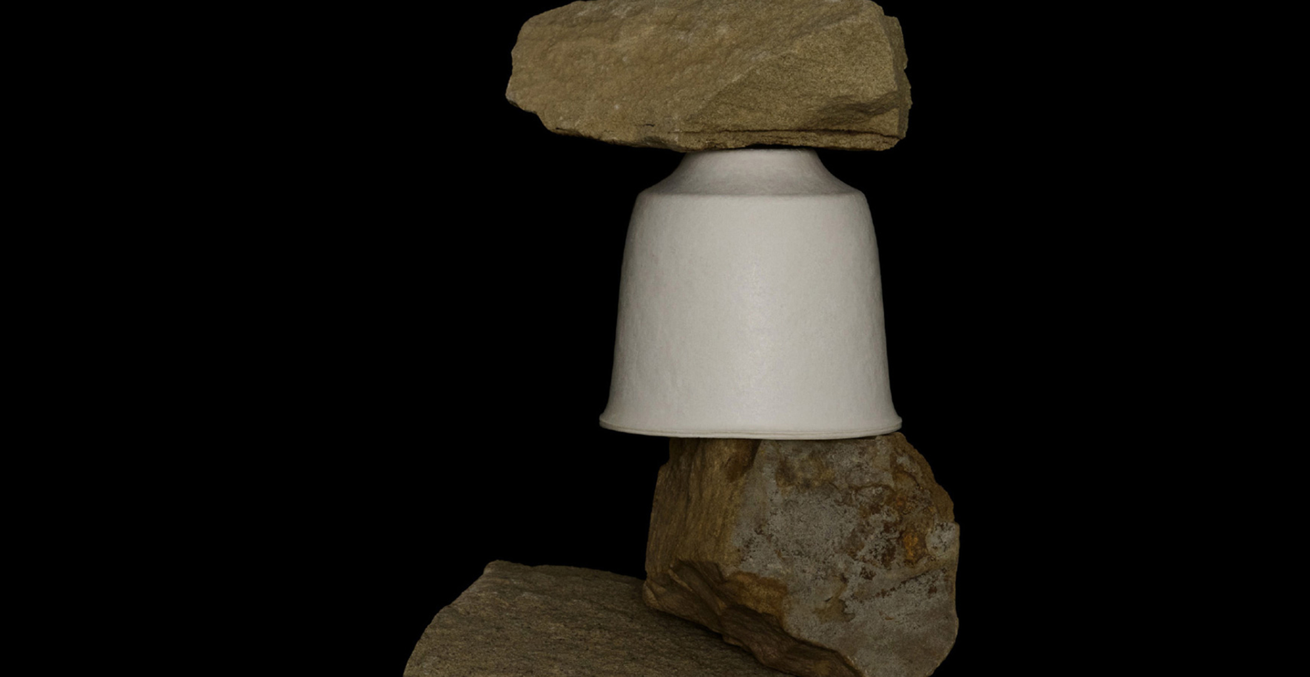 Image of Saboe T Collection tea container stacked amongst rocks with black background