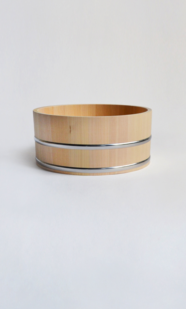 hinoki bath bucket with stainless rings against offwhite background