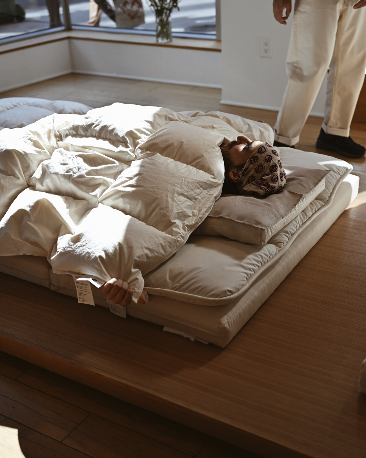 Man laying in futon set by Iwata