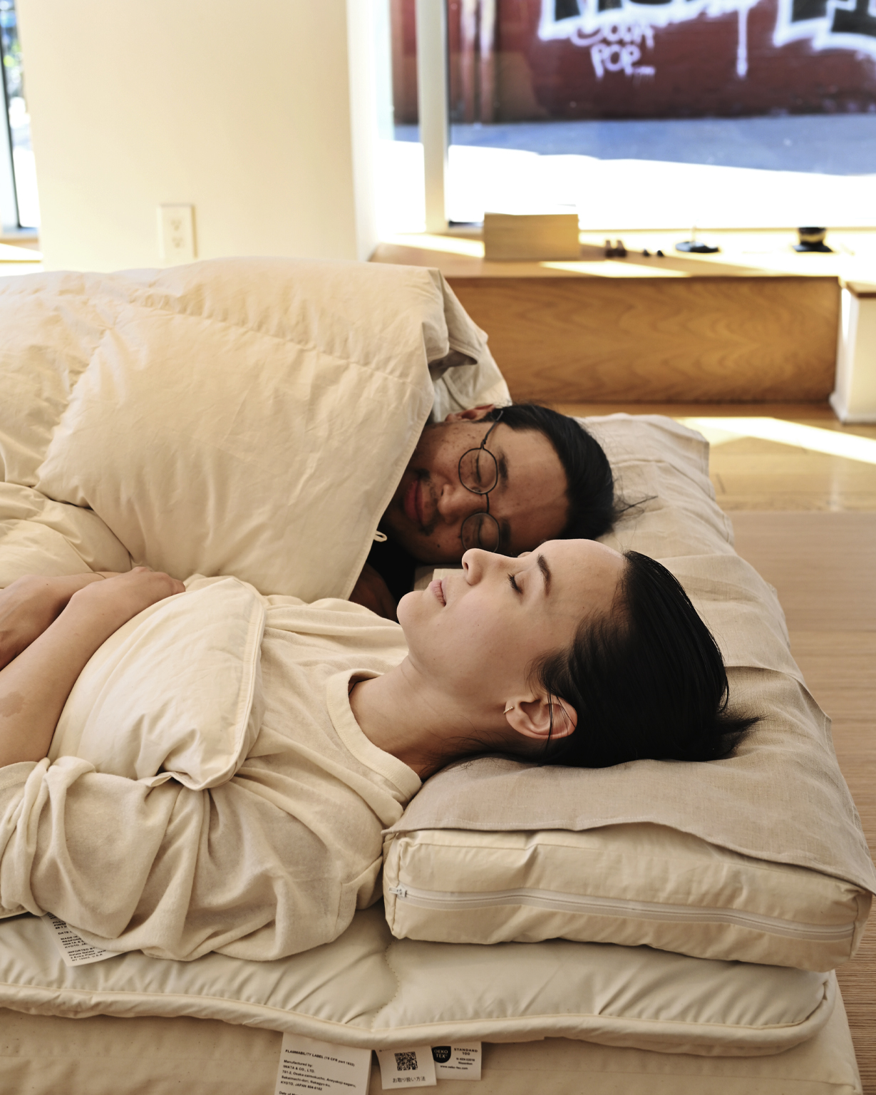 Stevenson and Angelique laying in futon set by Iwata