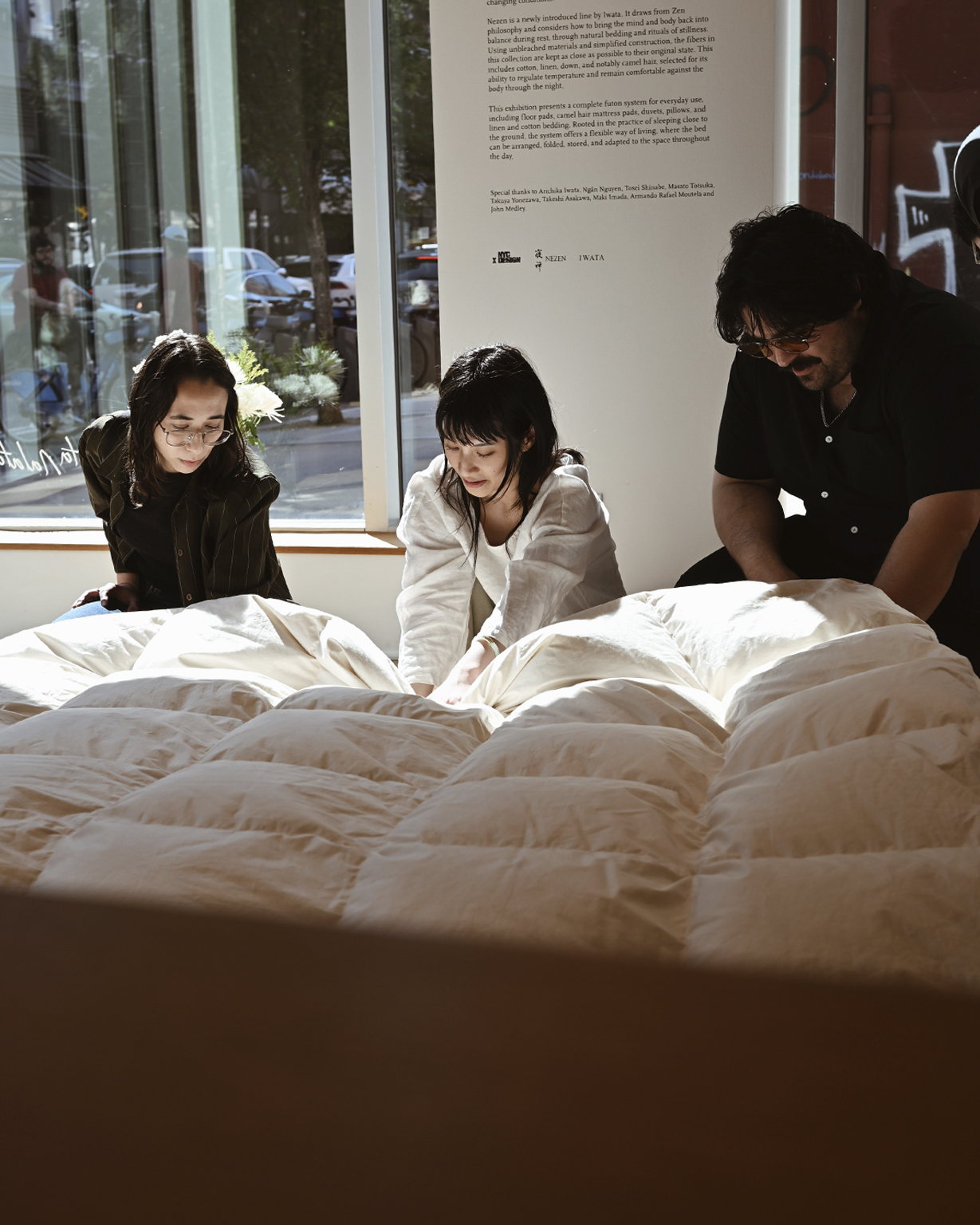 three people touching duvet by Iwata