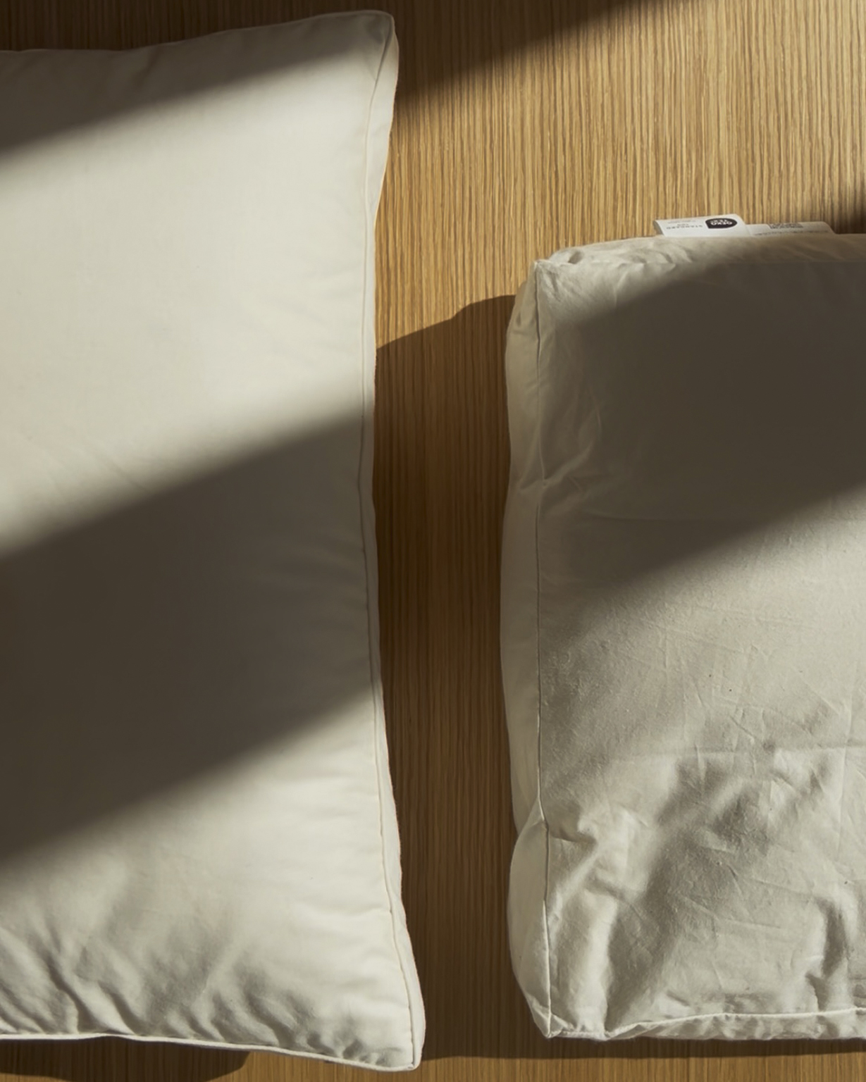 Up-close image of down and feather pillow and camel hair pillow by Iwata