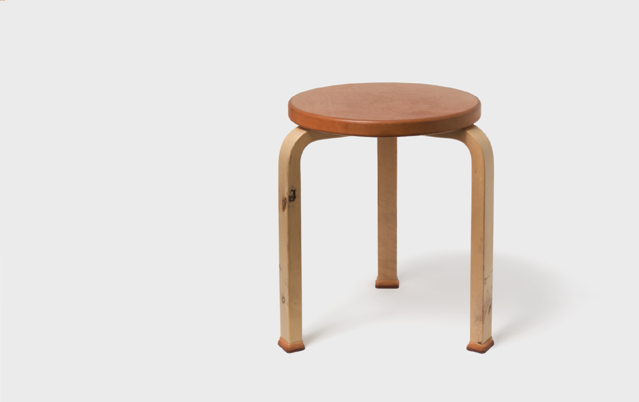 Aged stool by Hender Scheme x Artek on a gray background