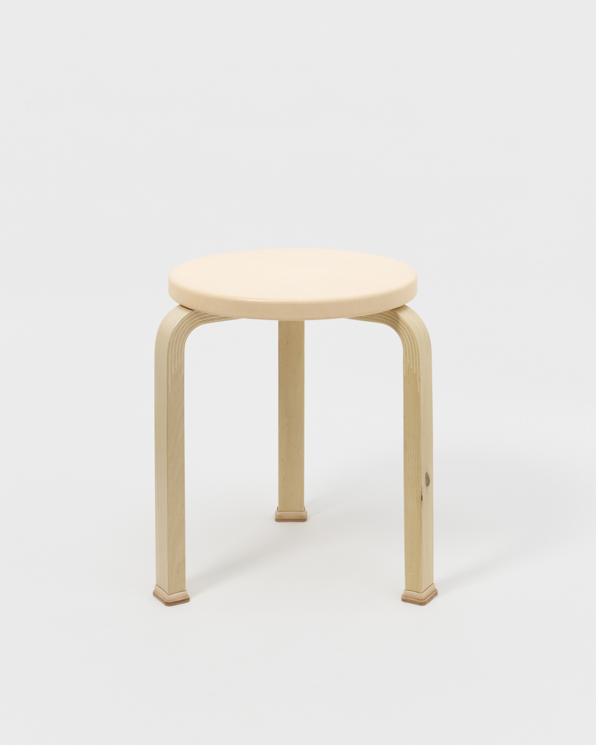 Stool with shoes by Hender Scheme x Artek on a gray background