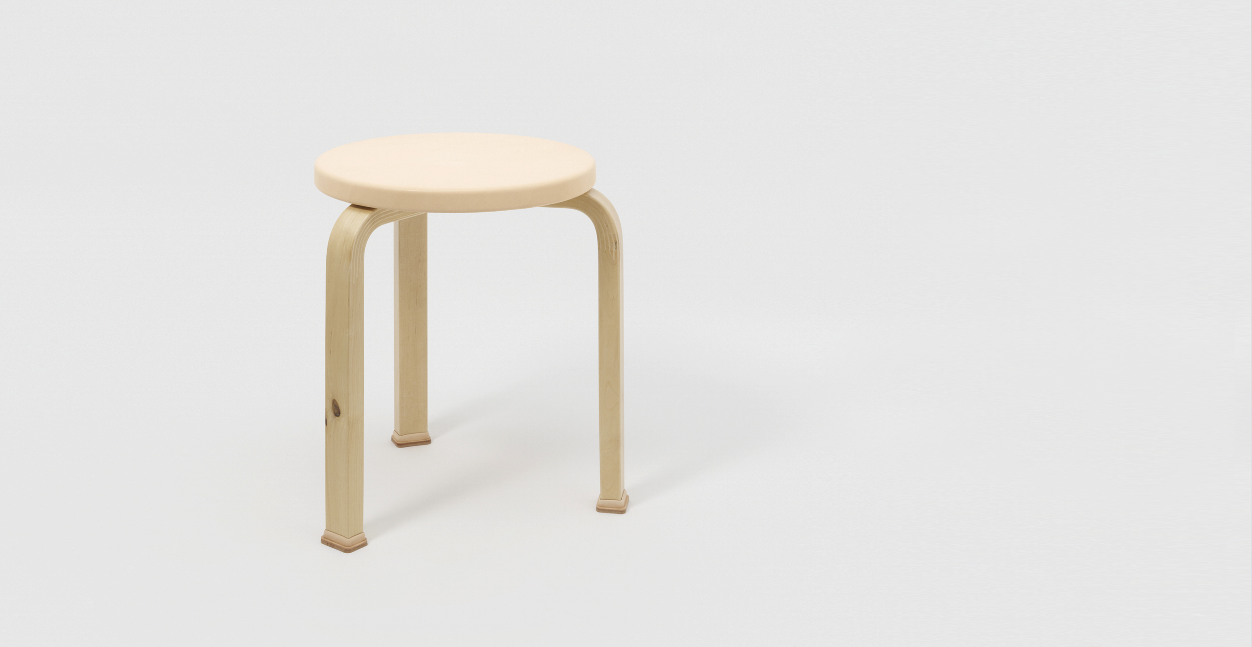 Hender Scheme and Artek Natural vegetan stool against offwhite background